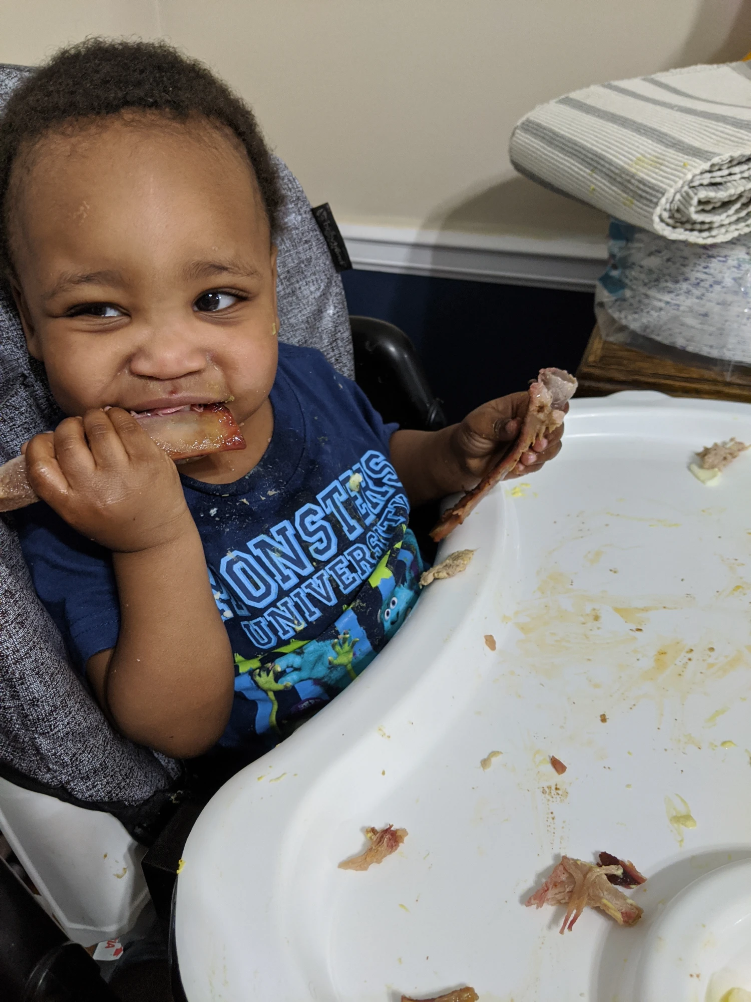 Izaak the month he was brought into the Case's home, eating Dad's BBQ ribs